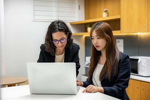 Two professionals discussing Interfax vs. Etherfax to make an informed decision about online fax solutions